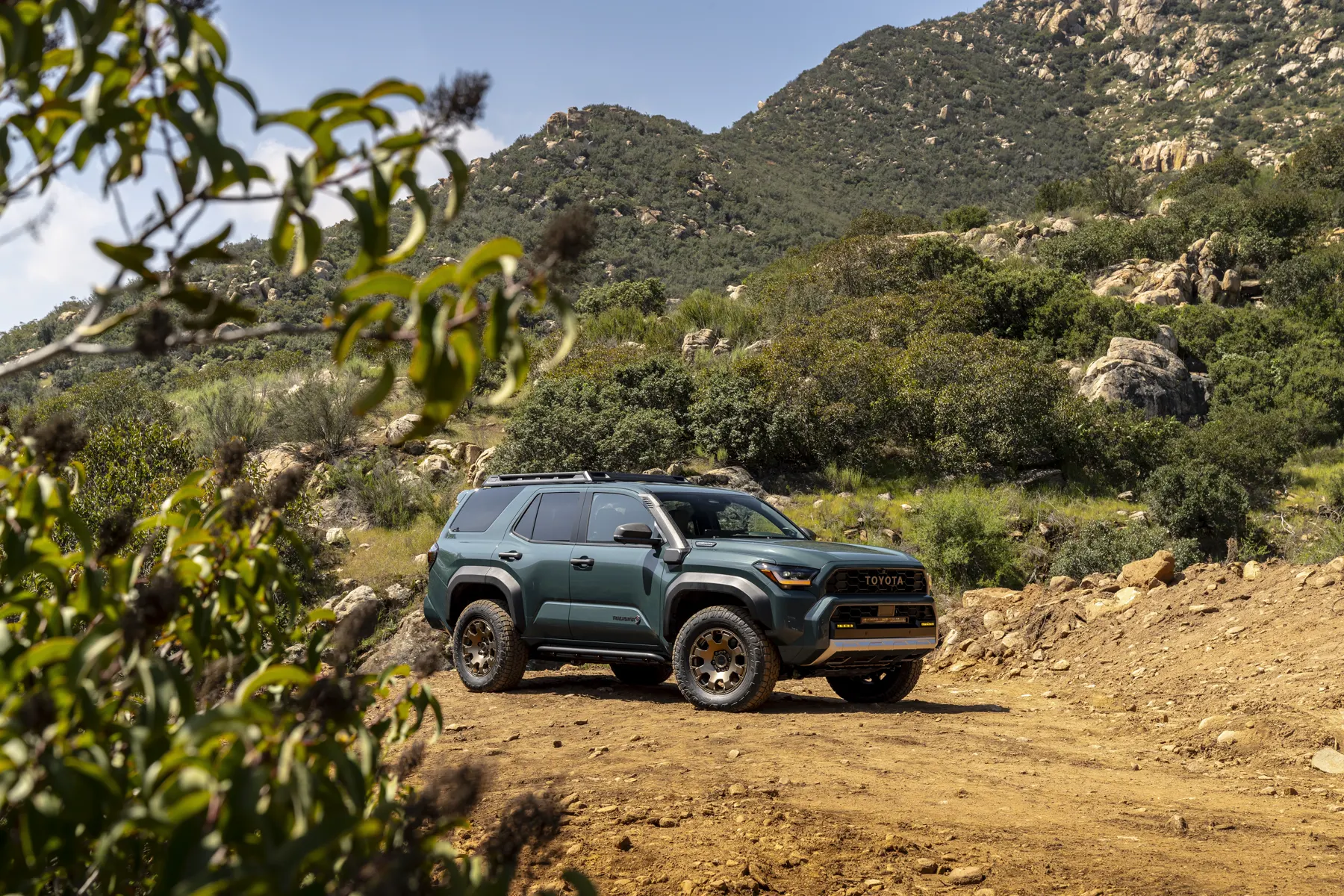 2025 Toyota 4Runner Trailhunter in Everest, front three-quarter on a dirt trail