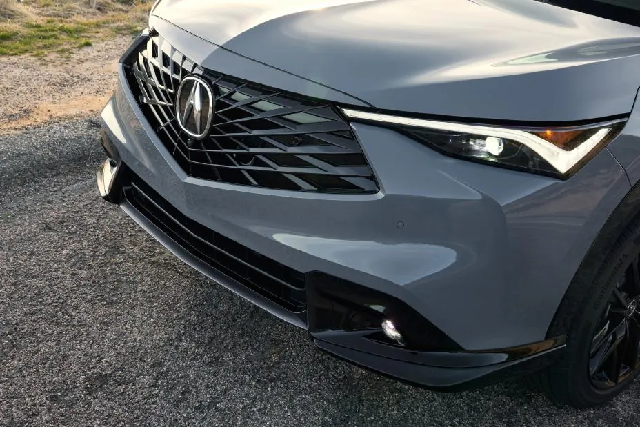 Gray 2026 Acura ADX, dead-front Diamond Pentagon grille with black mesh and a wide-set LED DRL under the side marker