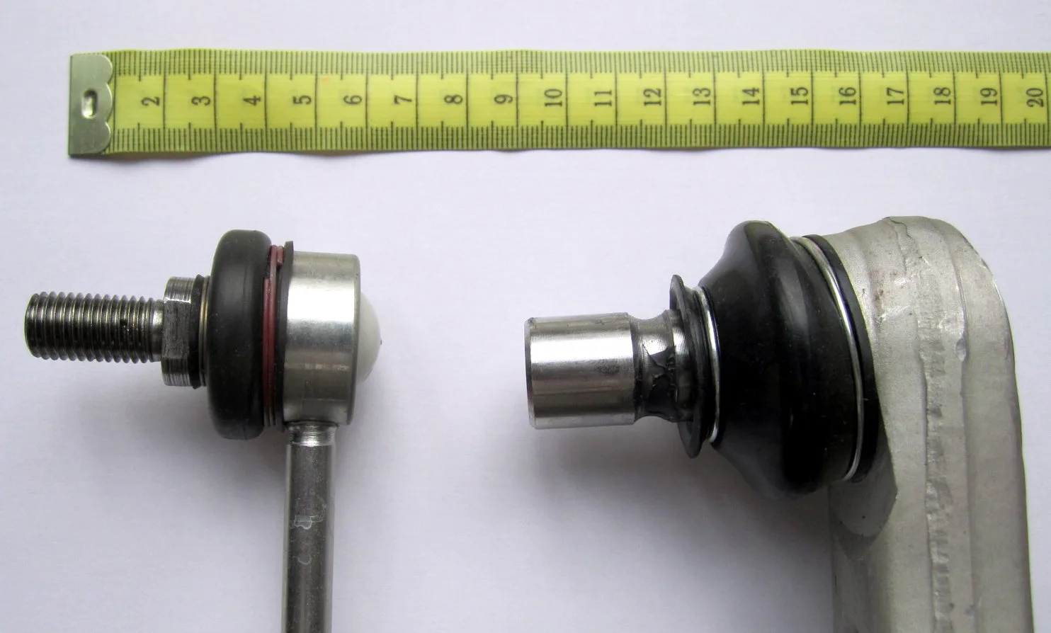 Front suspension on stands: lower control arms meet the knuckles at ball joints, with a stabilizer link beside them
