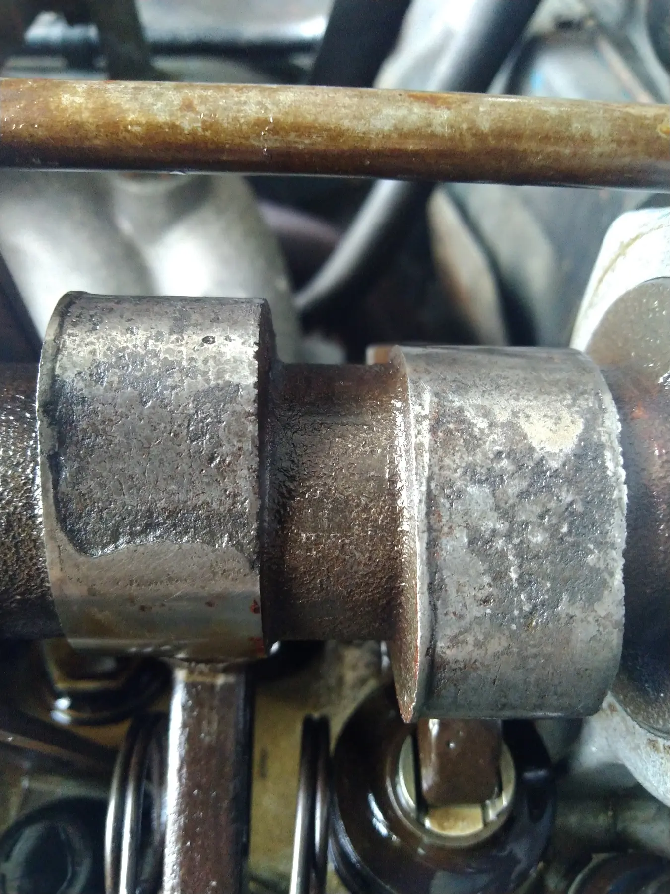 Close-up of a camshaft lobe with visible surface wear