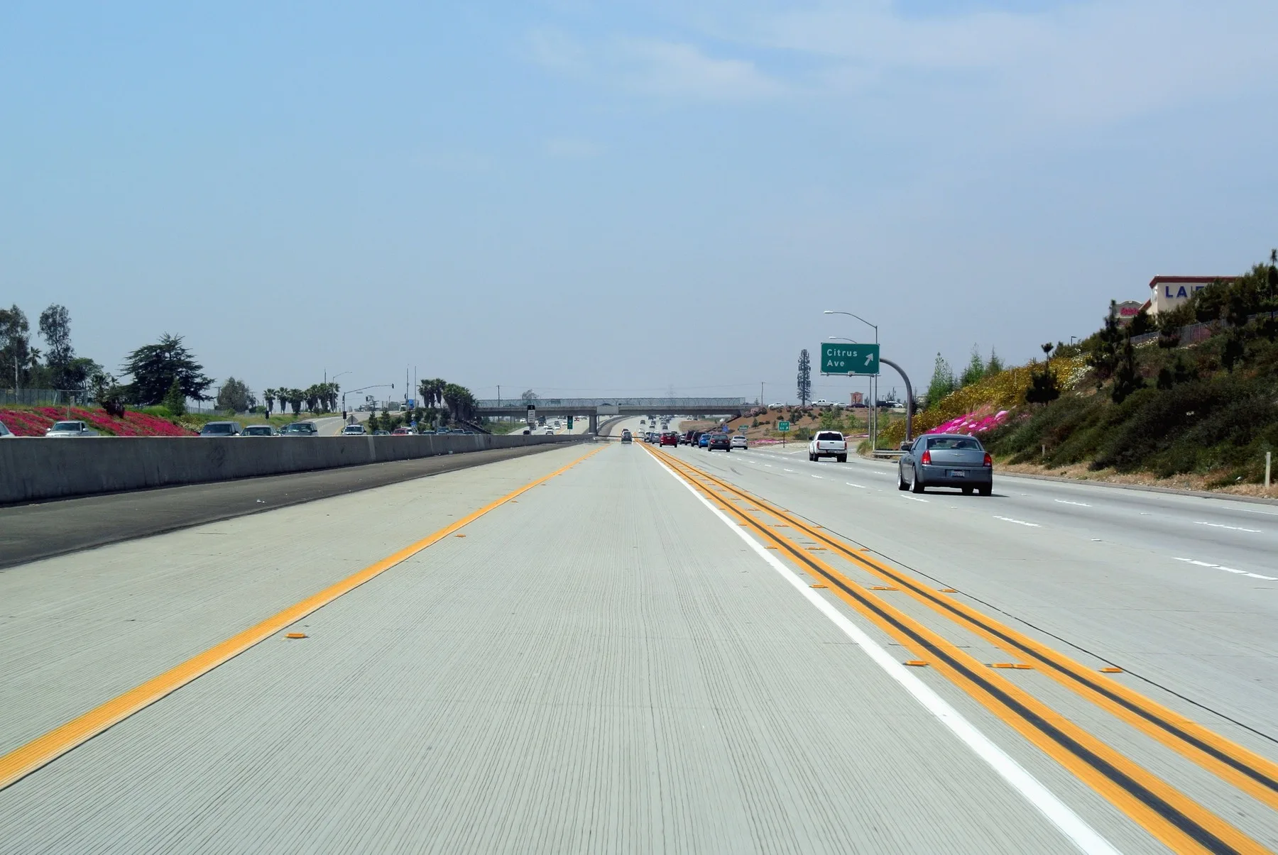 Carpool lane on the Foothill Freeway in Fontana, the left lane set off by white lines with a diamond painted on the pavement