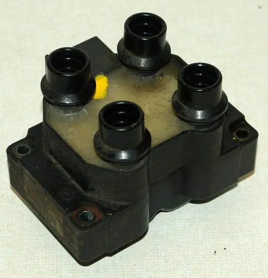 Ford EDIS wasted-spark coil pack with four towers and a yellow potting well
