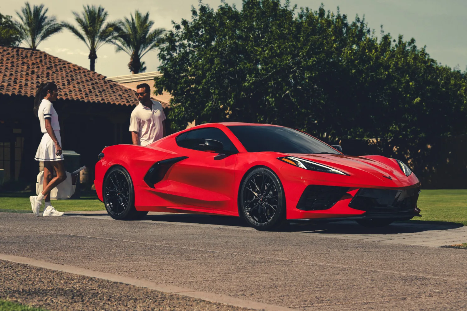 Red 2026 Chevrolet Corvette Stingray, front three-quarter on a sunny drive