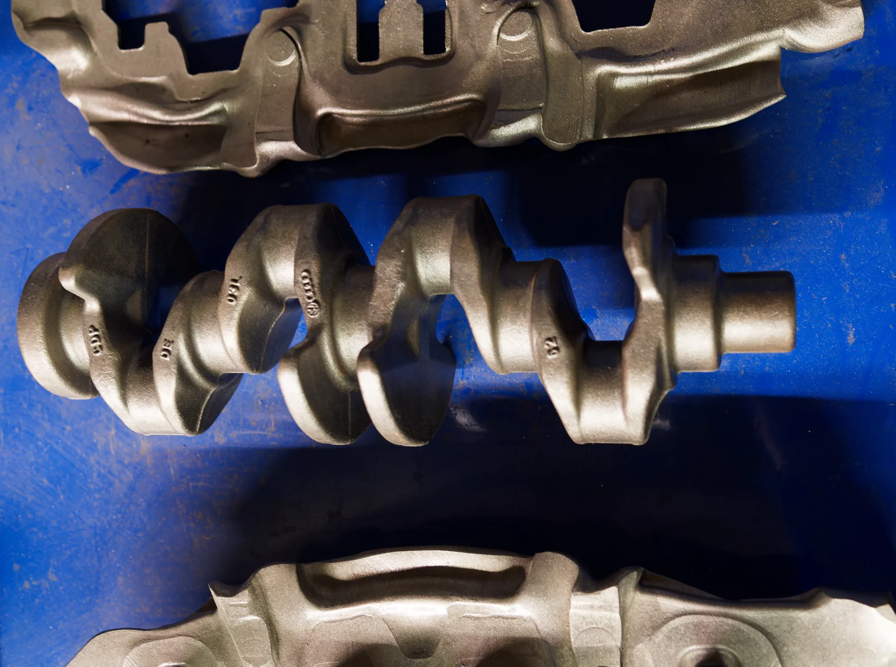Crankshaft displayed with journals, offset throws and counterweights visible