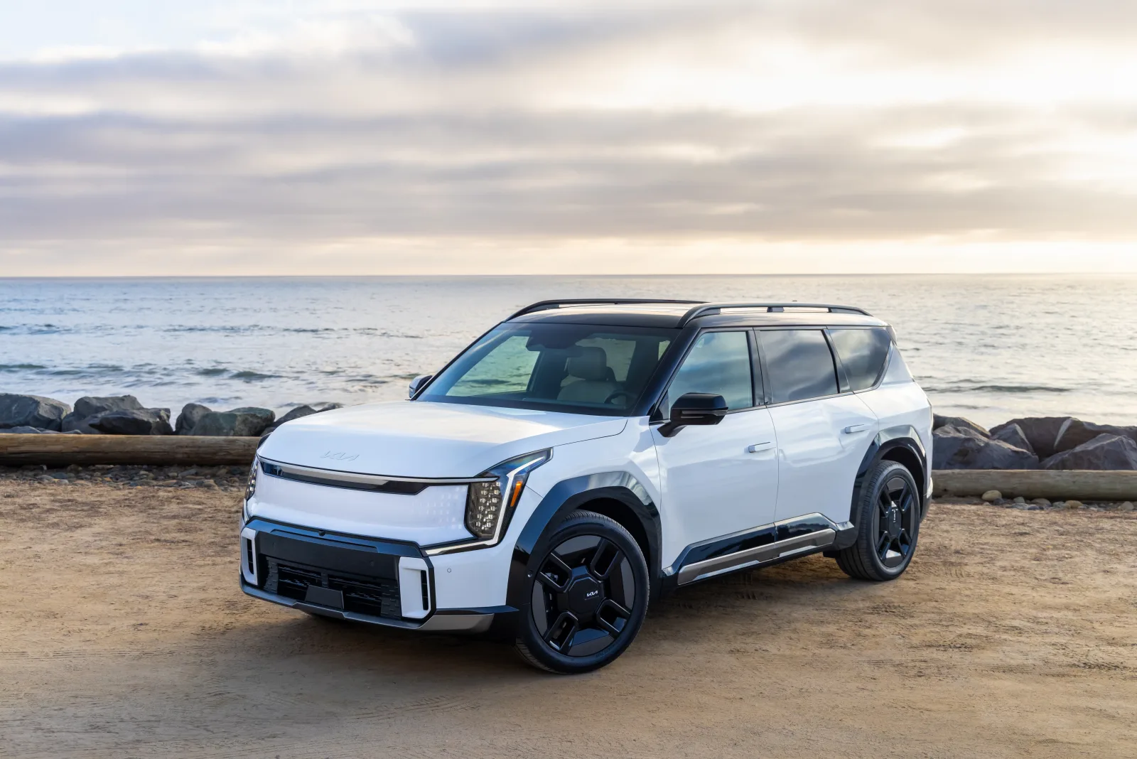 White 2026 Kia EV9, front three-quarter on a coastal lot with a closed tiger-nose face