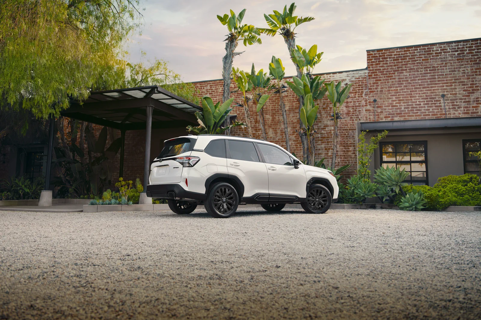 White 2026 Subaru Forester Sport Onyx Edition, rear three-quarter with dark 19-inch wheels and black cladding