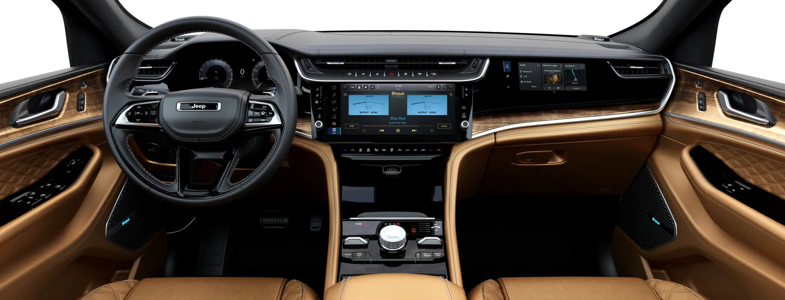 2026 Jeep Grand Cherokee cabin with a 12.3-inch center screen, wood dash, and tan quilted seats