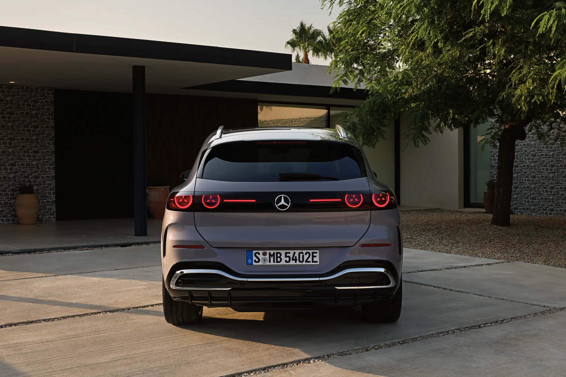 Close view of a 2027 Mercedes-Benz GLC Electric illuminated iconic grille with a lit central star, contour lighting, and backlit mesh, European model shown