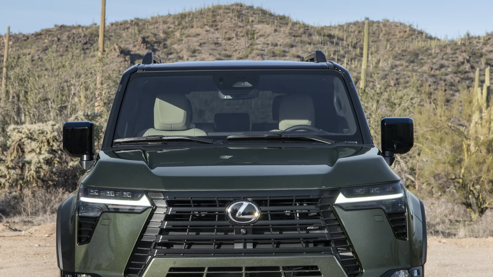 Nori Green 2026 Lexus GX, dead-front close of the spindle grille and Triple-Beam LED lamps