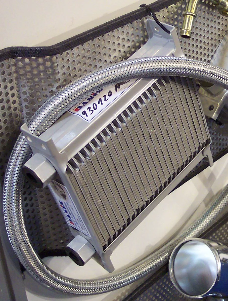 Heater-core fin stack and coolant pipes visible during work on a vehicle