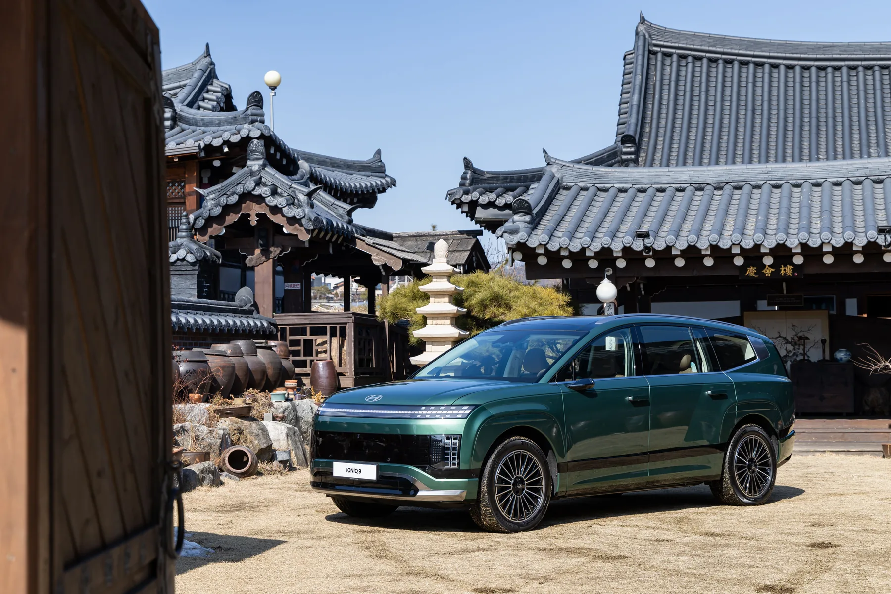 Green 2026 Hyundai Ioniq 9, front three-quarter with parametric-pixel lamps in a courtyard