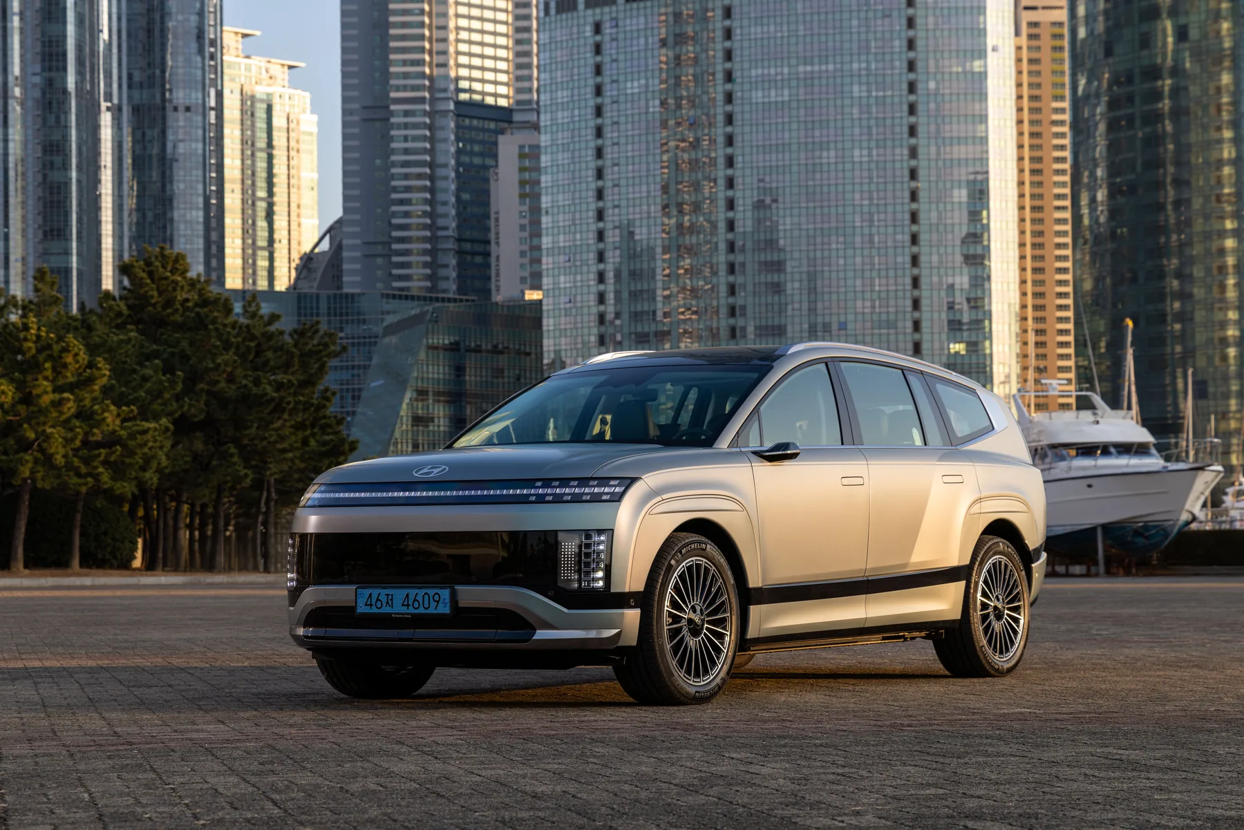 Champagne 2026 Hyundai Ioniq 9, front three-quarter on a waterfront plaza