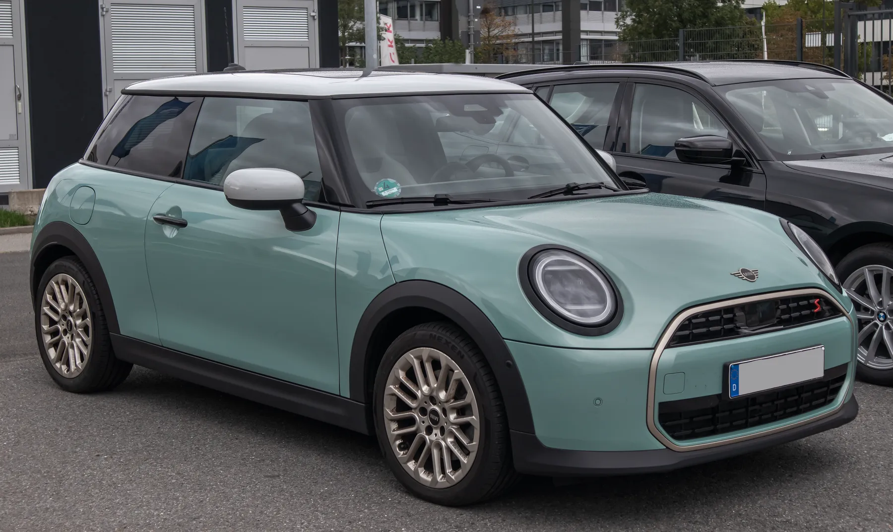 Front view of a Mini Cooper S in Favoured trim, an F66, with an octagonal grille and round headlights carrying a horizontal daytime lamp