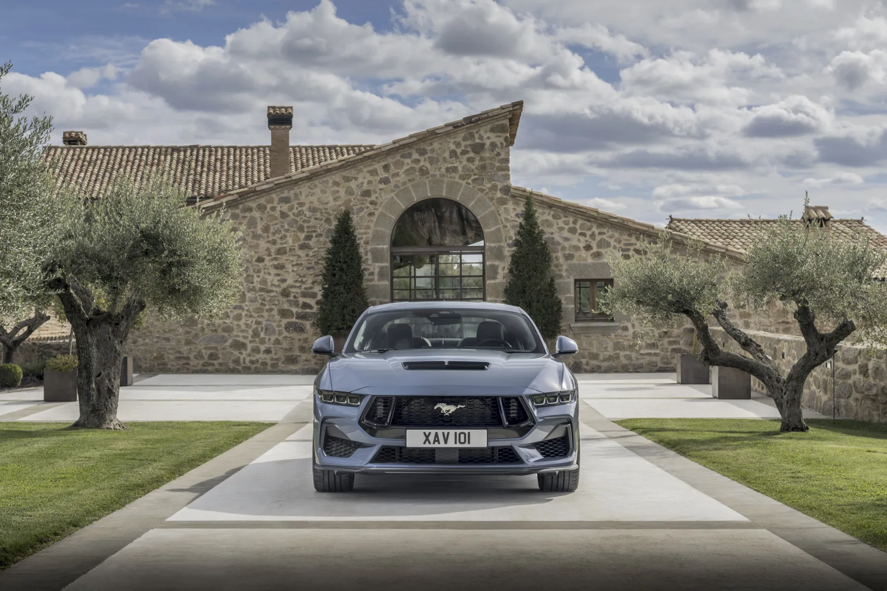 Slate 2026 Ford Mustang GT Fastback, straight-on nose with tri-bar lamps and a long hood