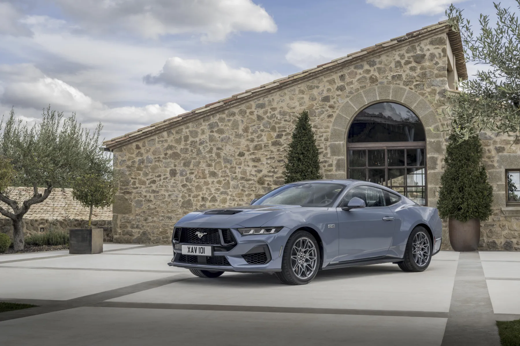 Slate 2026 Ford Mustang GT Fastback, front three-quarter with a long hood and 5.0 fender badge