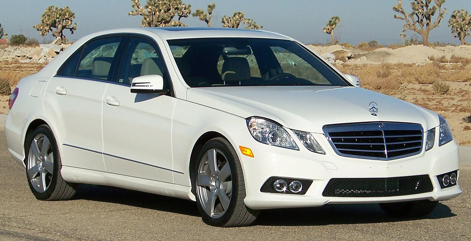 White Mercedes-Benz E-Class sedan in an official NHTSA test photograph