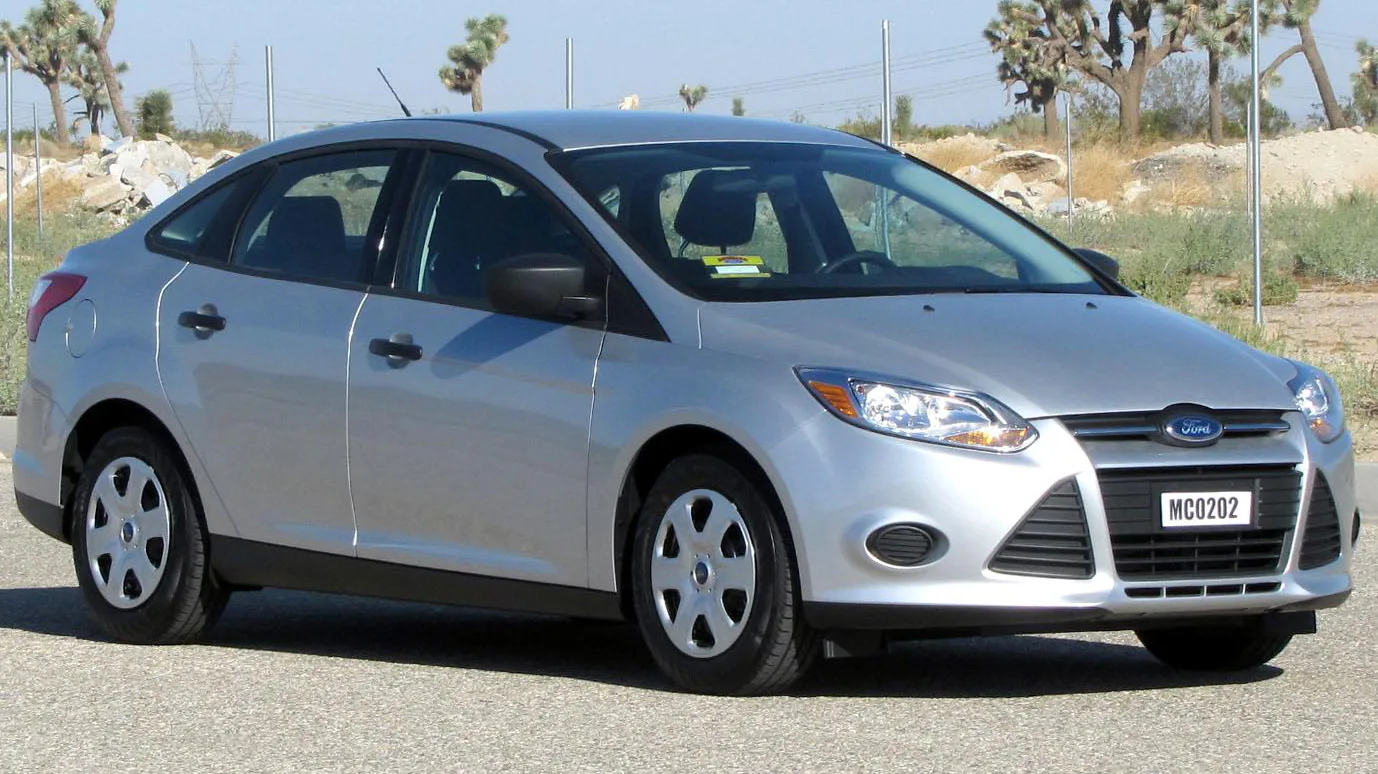 Silver Ford Focus sedan in an official NHTSA test photograph