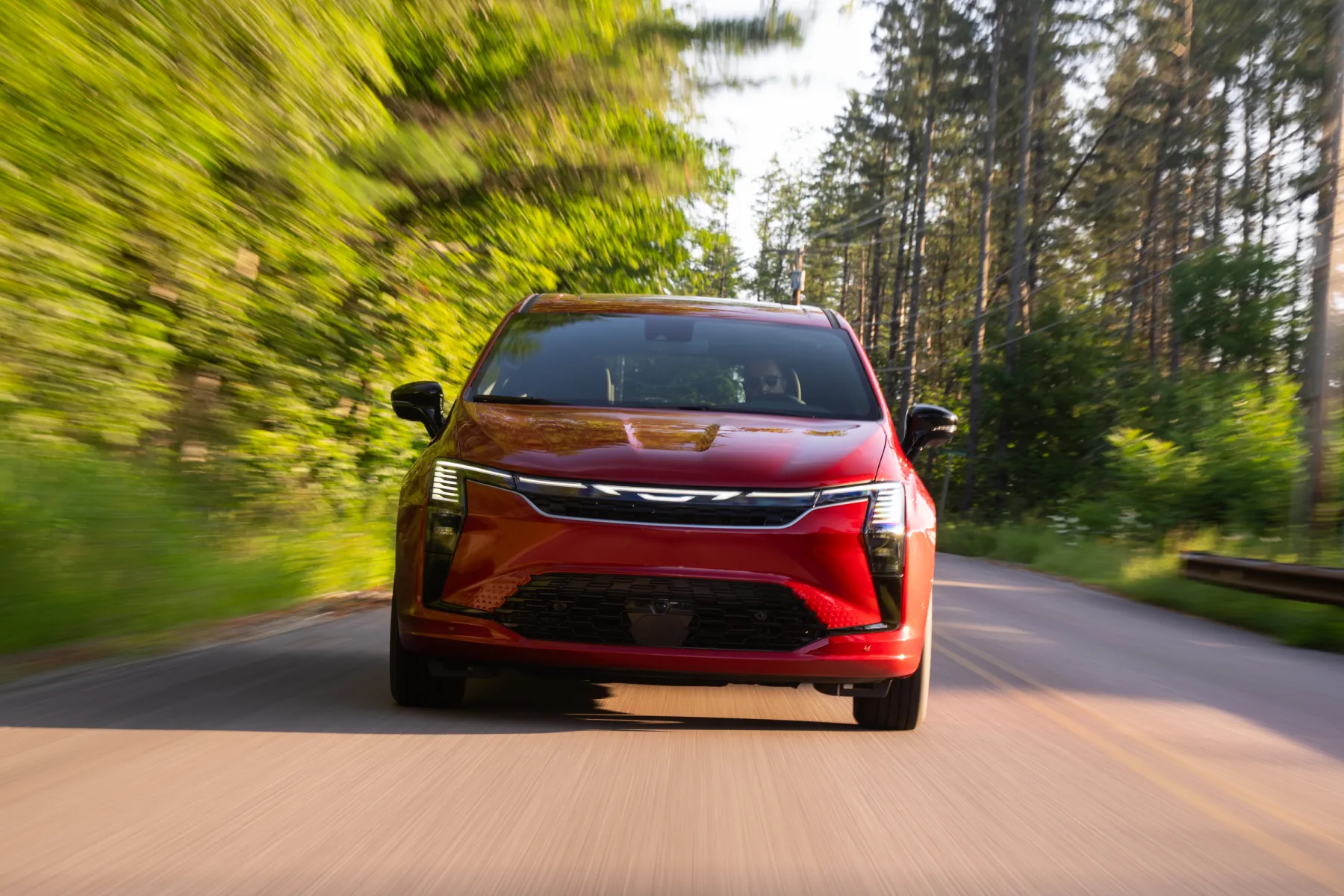 Red 2027 Chrysler Pacifica Limited, rear three-quarter in a studio with a lightbar applique and an updated wing badge