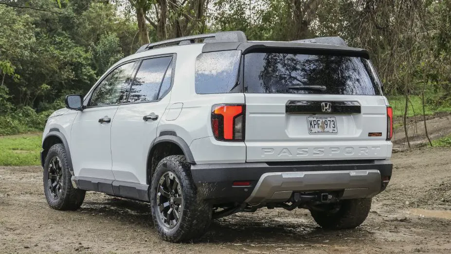 White 2026 Honda Passport TrailSport, rear three-quarter on dirt with PASSPORT stamped in the steel tailgate