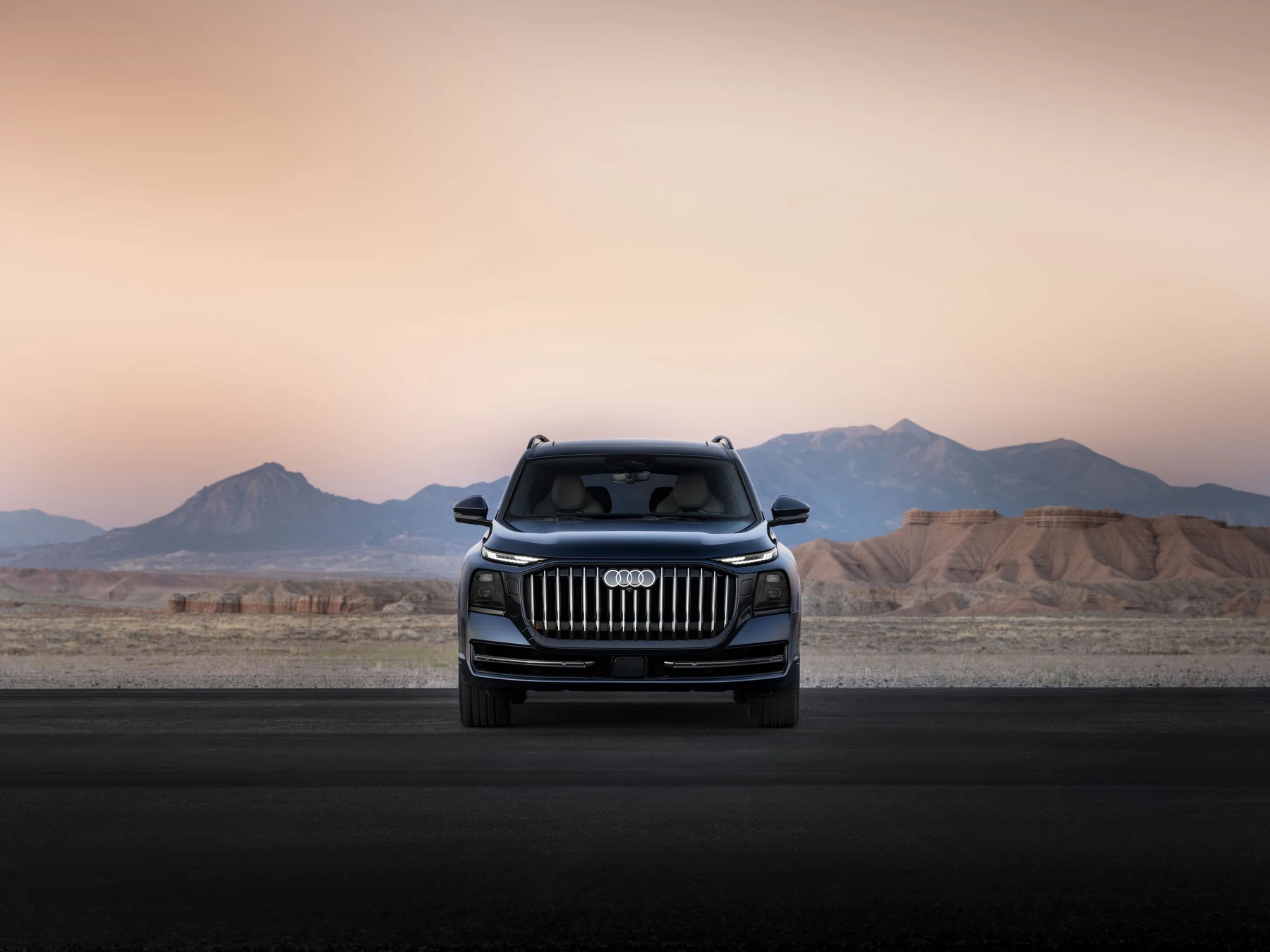 Dark blue Audi Q9, U.S.-specification release image, viewed head-on with an upright grille and wide-set lamps