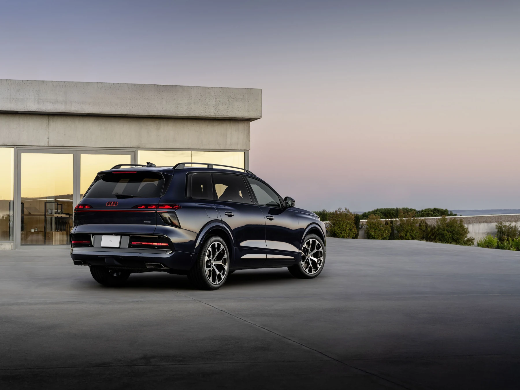 Dark blue Audi Q9, U.S.-specification release image, rear three-quarter