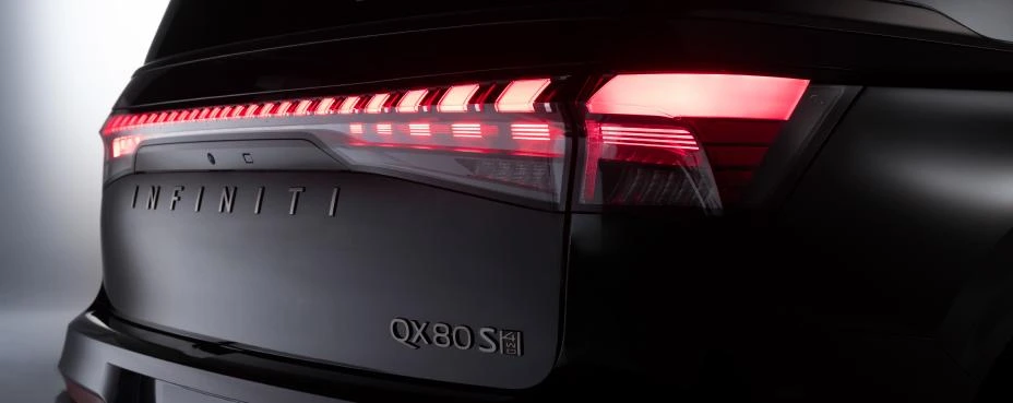 Black 2026 Infiniti QX80 SPORT, rear studio with a full-width LED bar, INFINITI lettering, and QX80 S badge