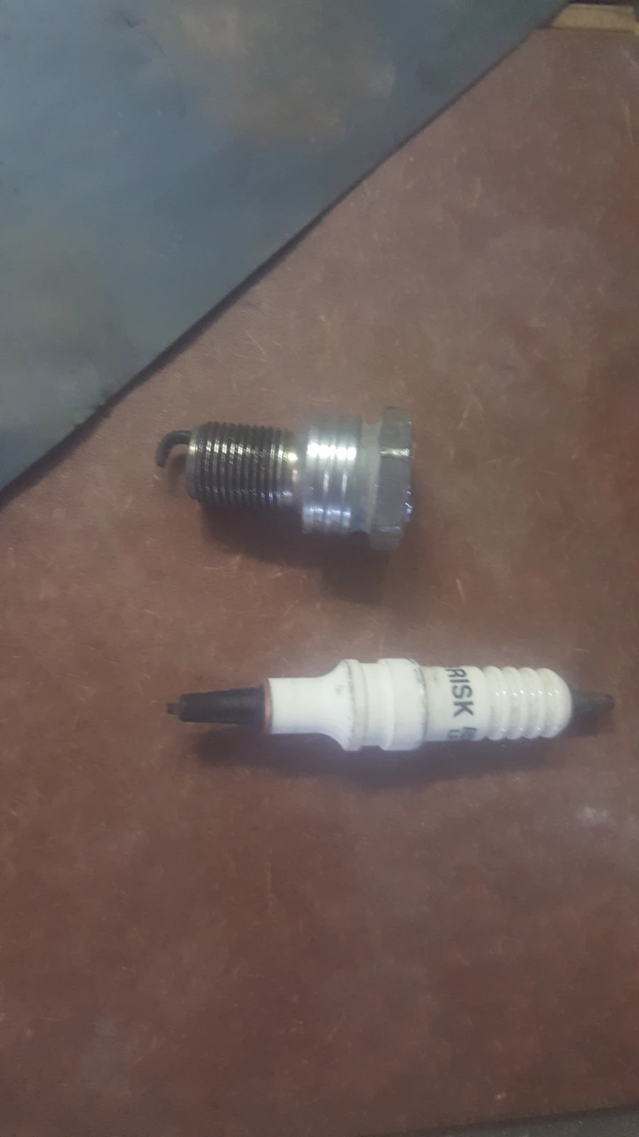 Spark plug snapped in two, ceramic insulator broken off the threaded shell