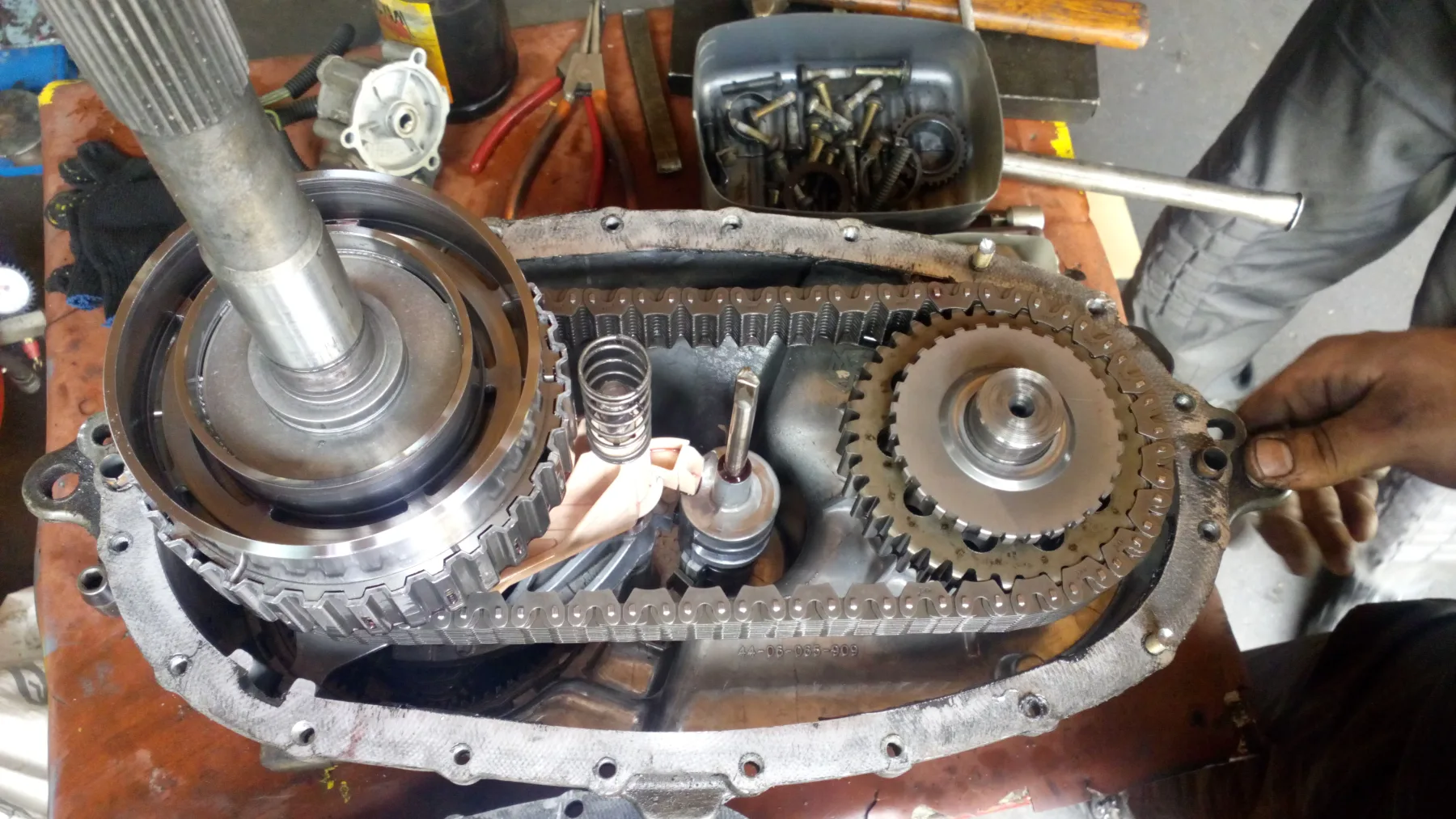 Opened transfer-case housing with a Morse chain wrapped on two sprockets