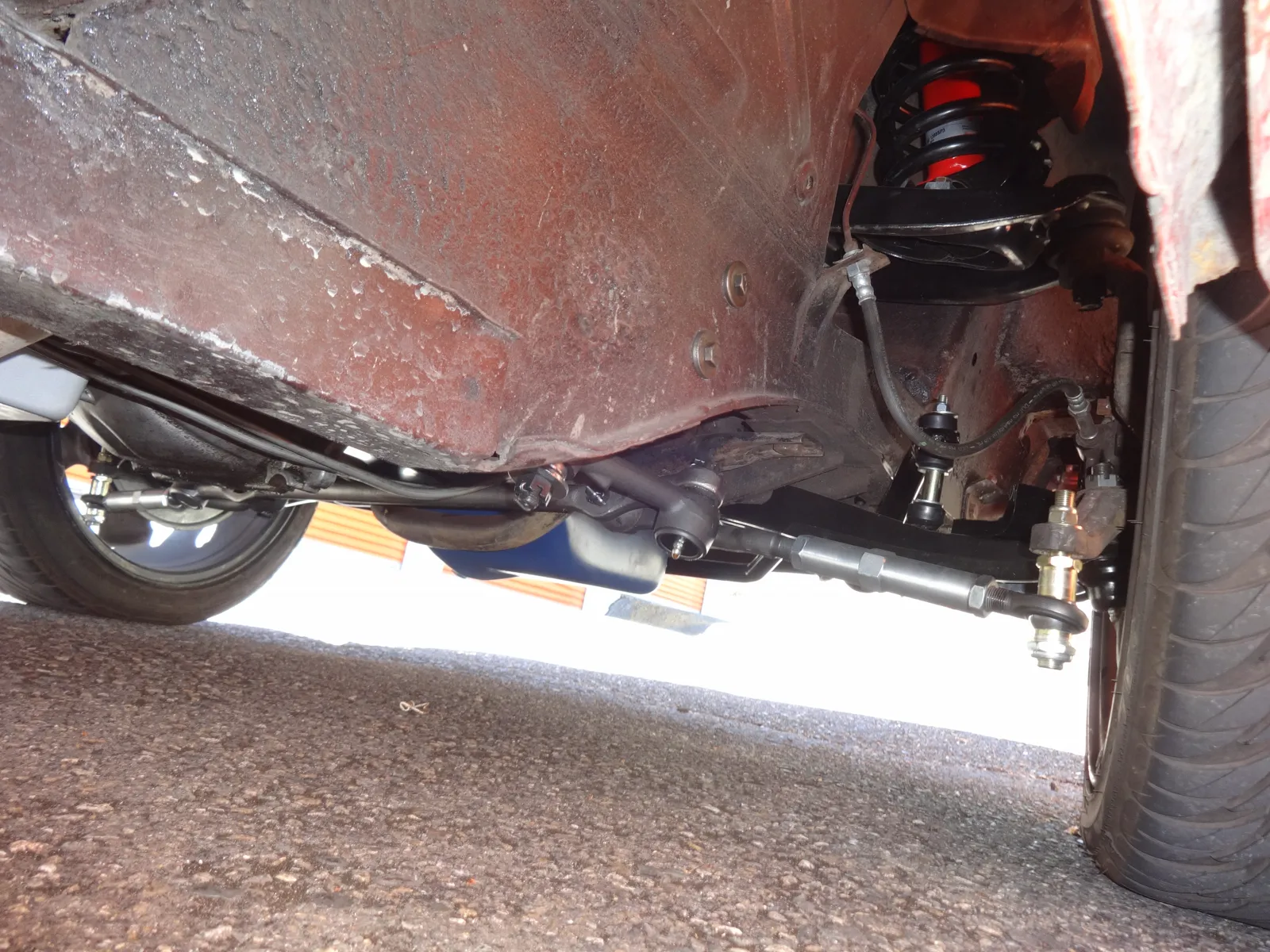 1965 Mustang from below: adjustable outer tie rod to the spindle, inner rod and center ball toward mid-car